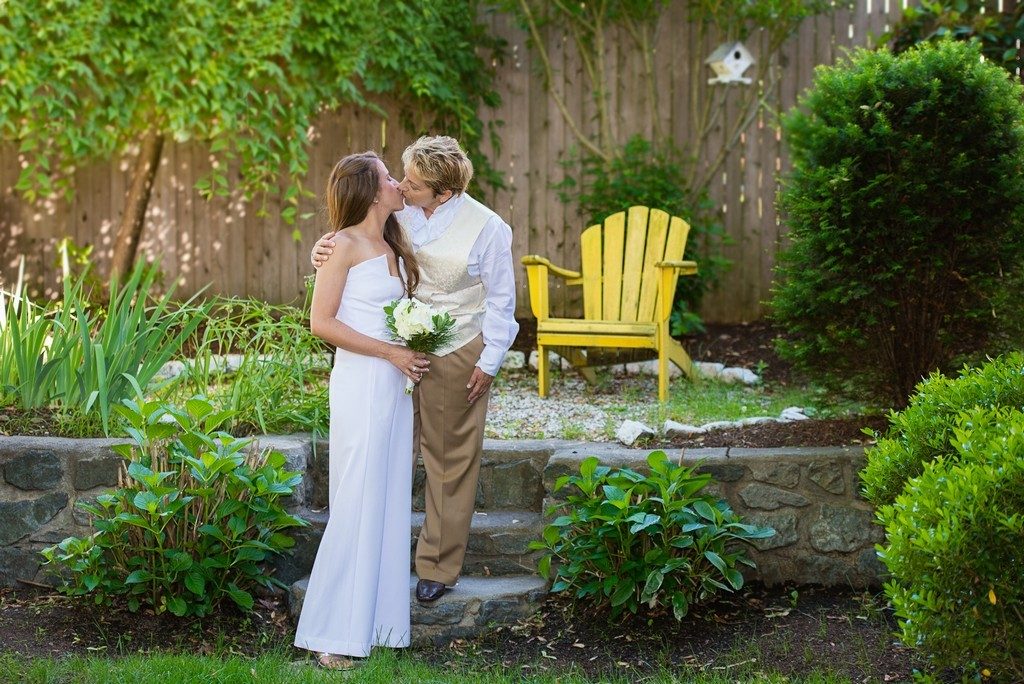 Happy wedding couple kissing on backyard