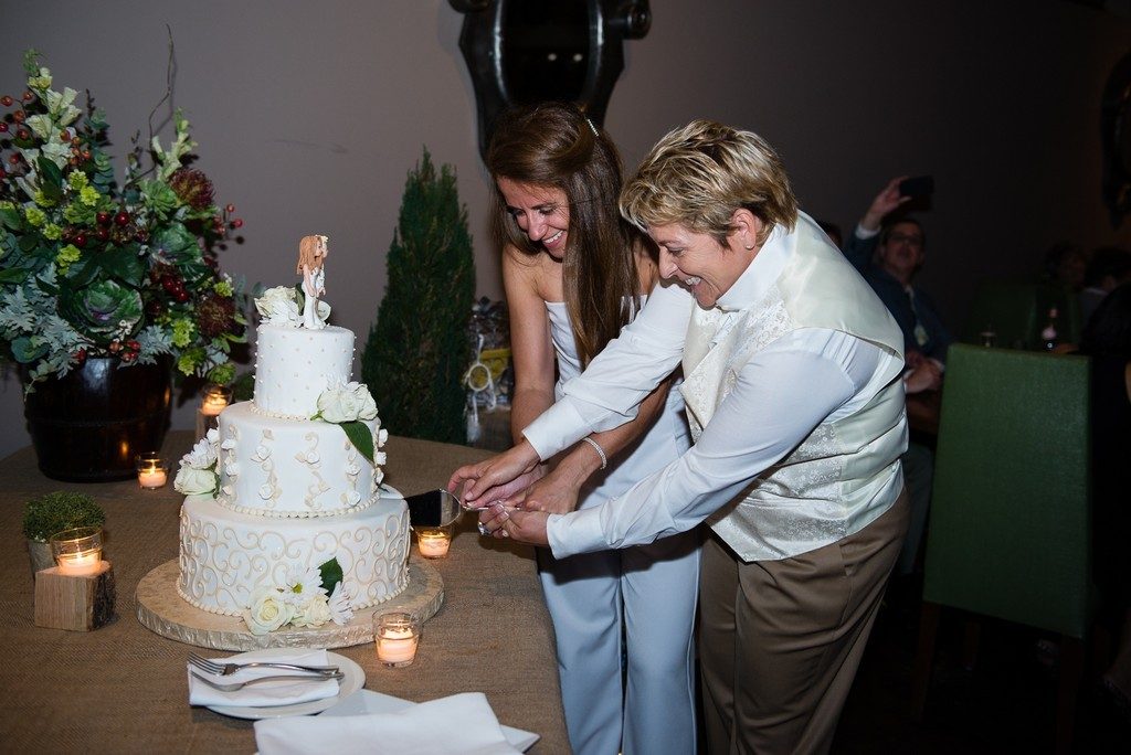 Brides cutting the cake at wedding reception in Burlington ma