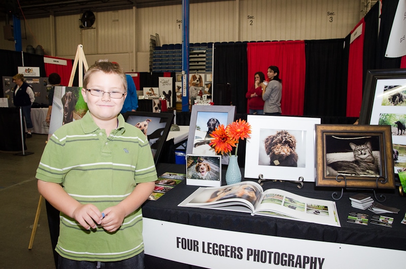 boy on display table at pet expo