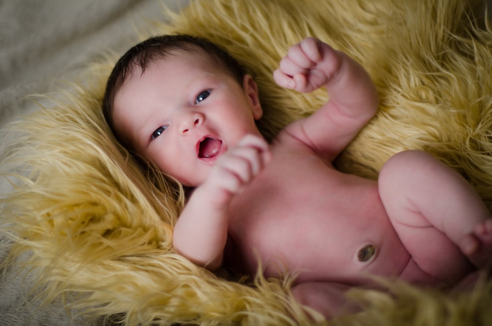newborn baby on yellow fur