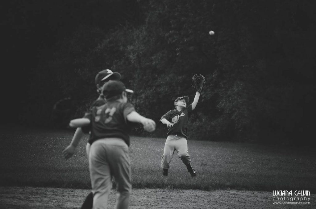 boy on baseball game catching a ball