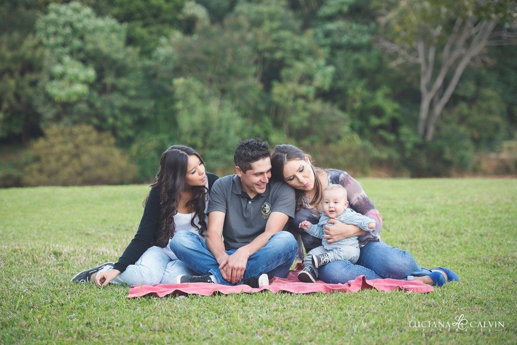 family seating on grass for family portrait