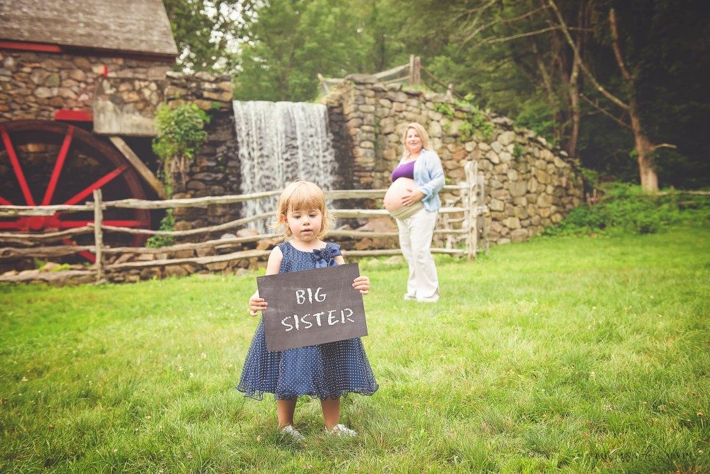 little girl announcing little sisters coming