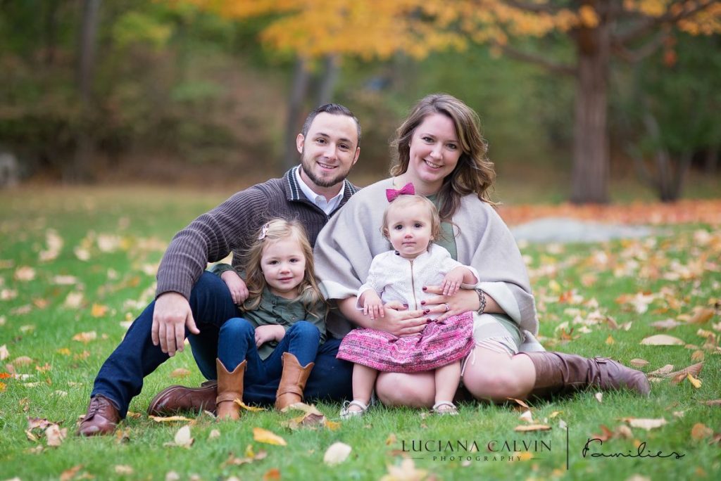 Family seating on grass for family portrait