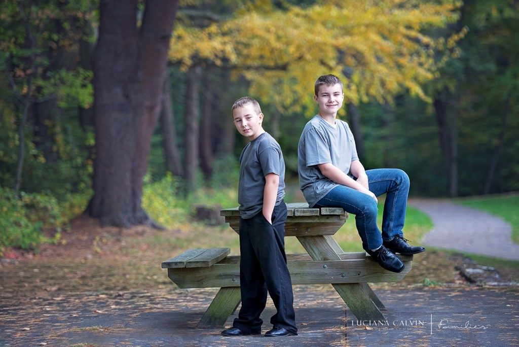 boys seating on a picnic bench at the park