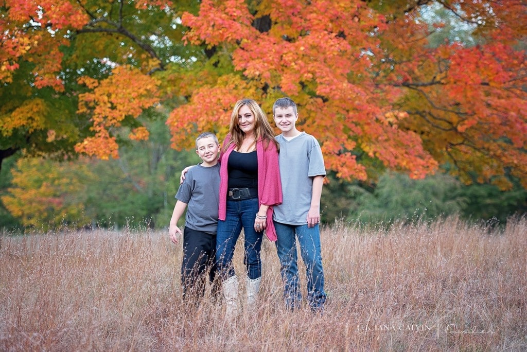 Mother and sons under a fall orange tree