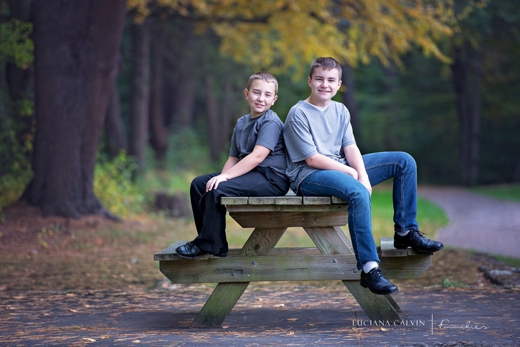 boys seating on a picnic bench at the park