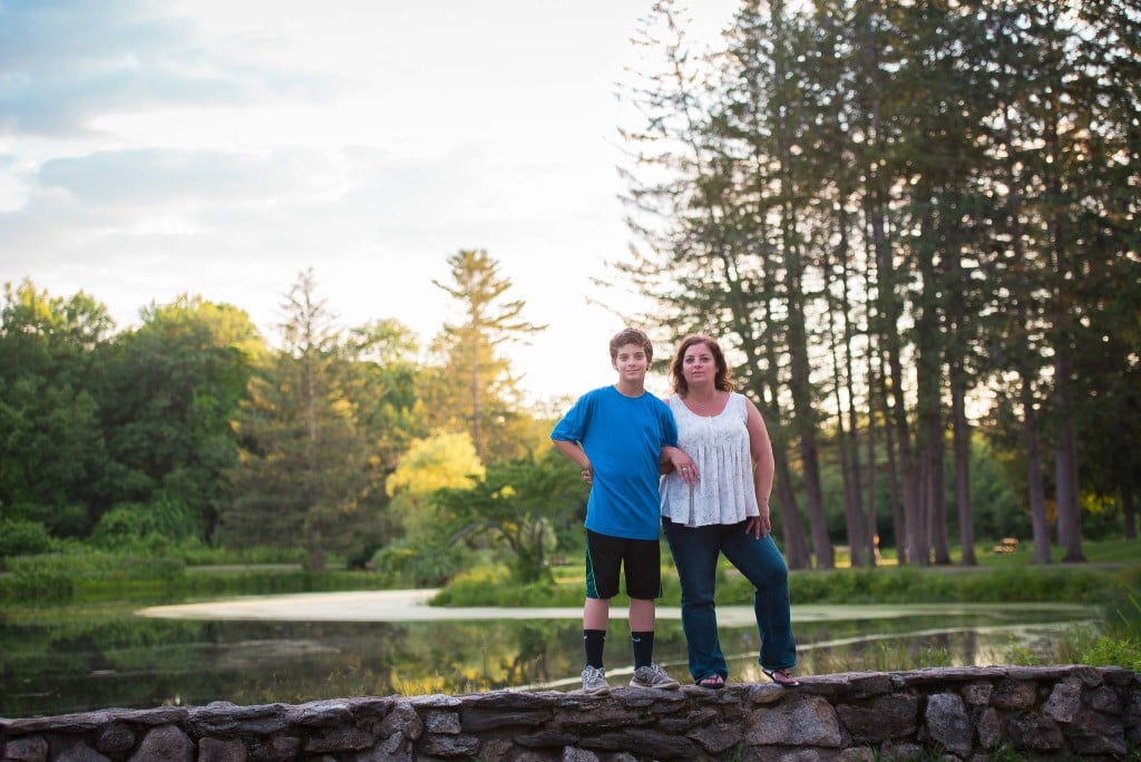 Mother and son seating on bench on Bensons park Hudson NH