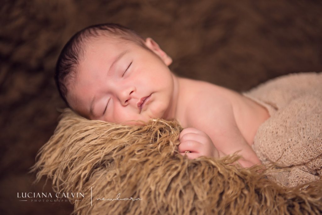 newborn baby sleeping on a basket