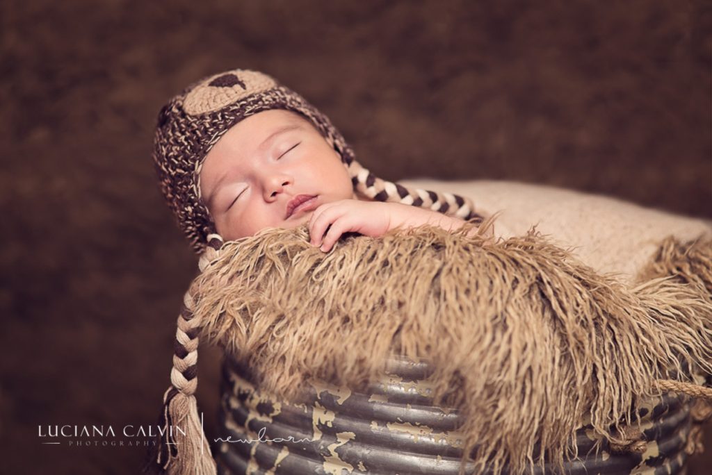 newborn baby sleeping on a basket