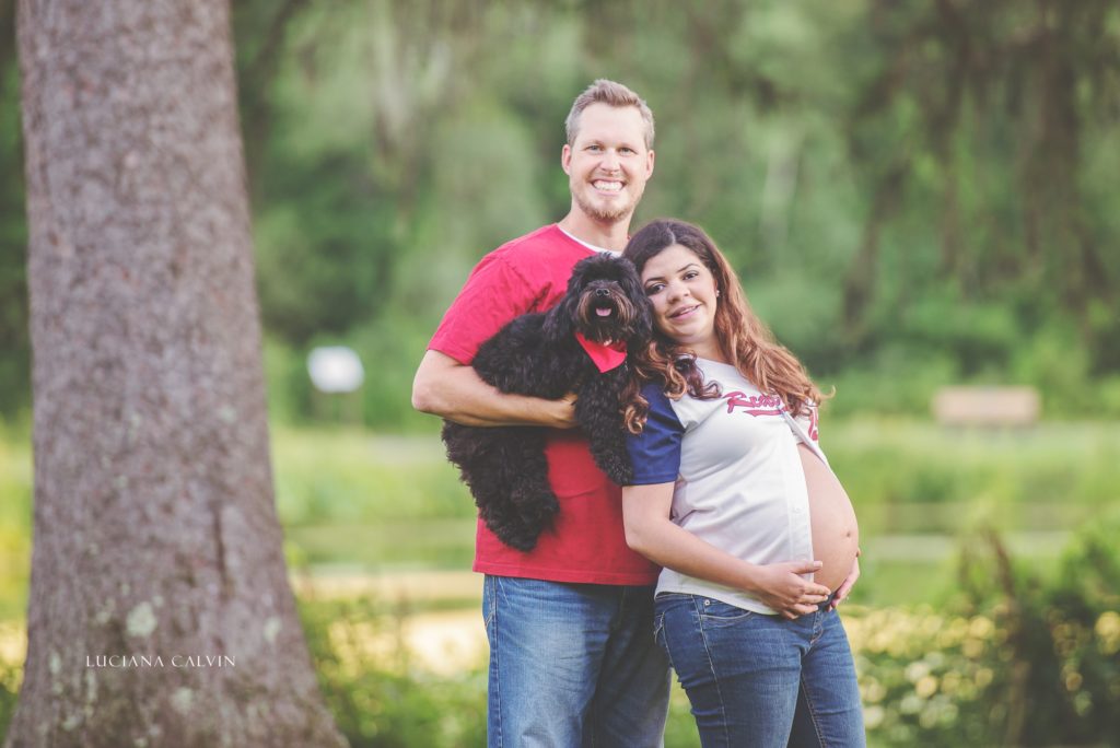 Pregnant couple holding a dog