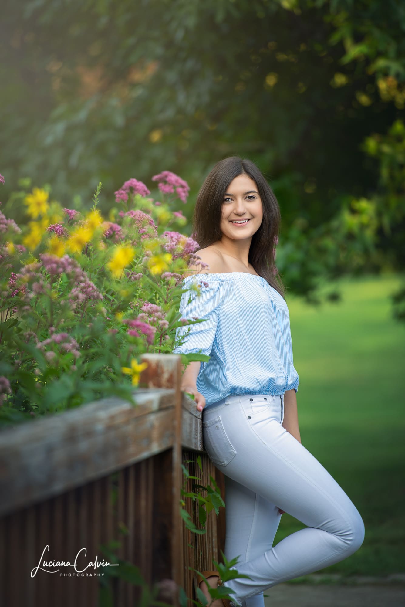 Senior portrait beside the wildflower beds at Acton Arboretum in Acton MA