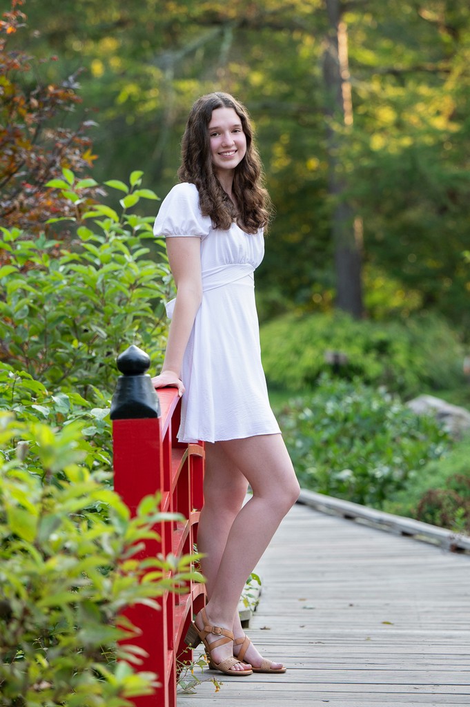 Chelmsford High School senior pictures in a garden with red bridge Acton, MA
