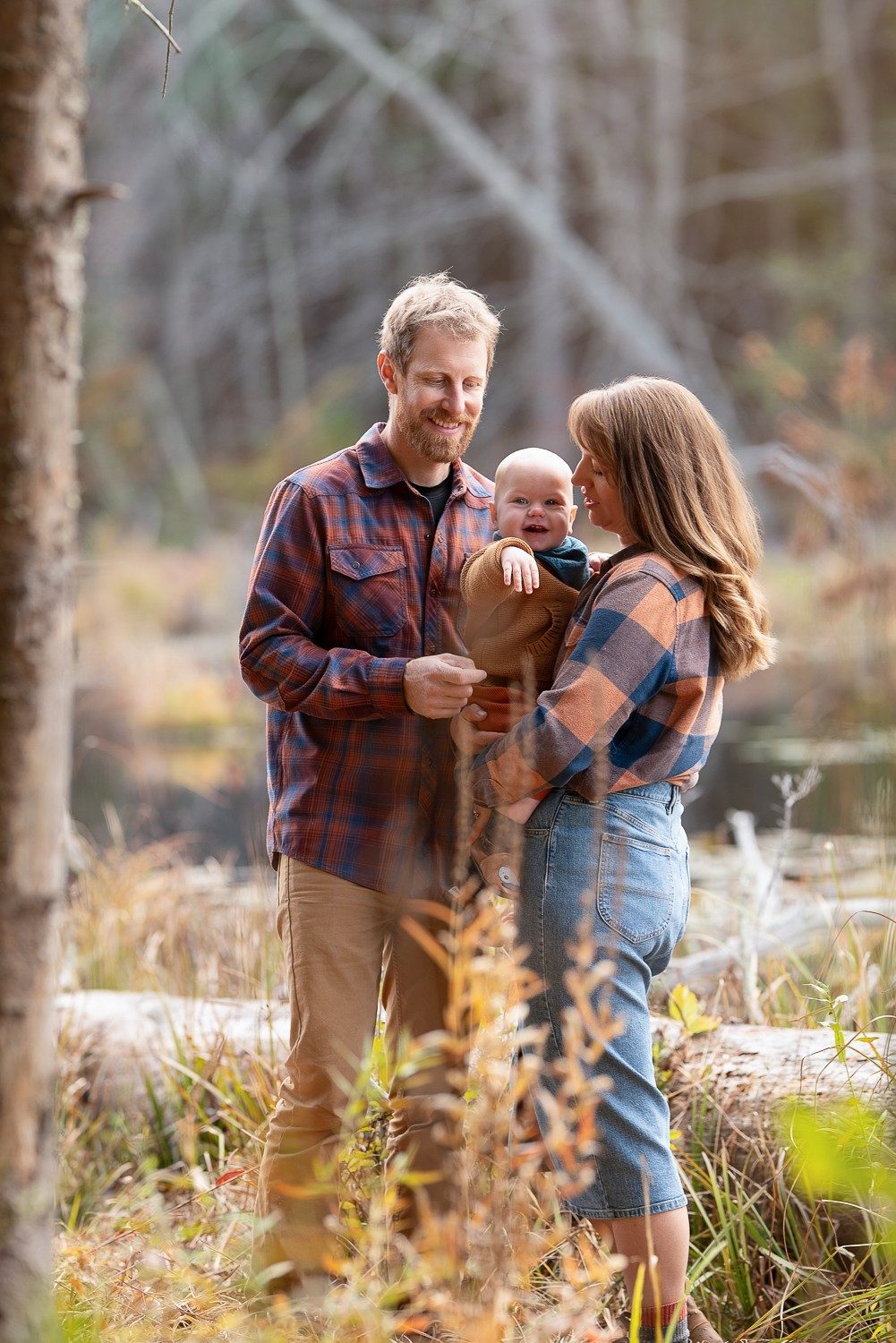 Family of three at the wetland edge in autumn at Assabet River National Wildlife Refuge in Sudbury MA