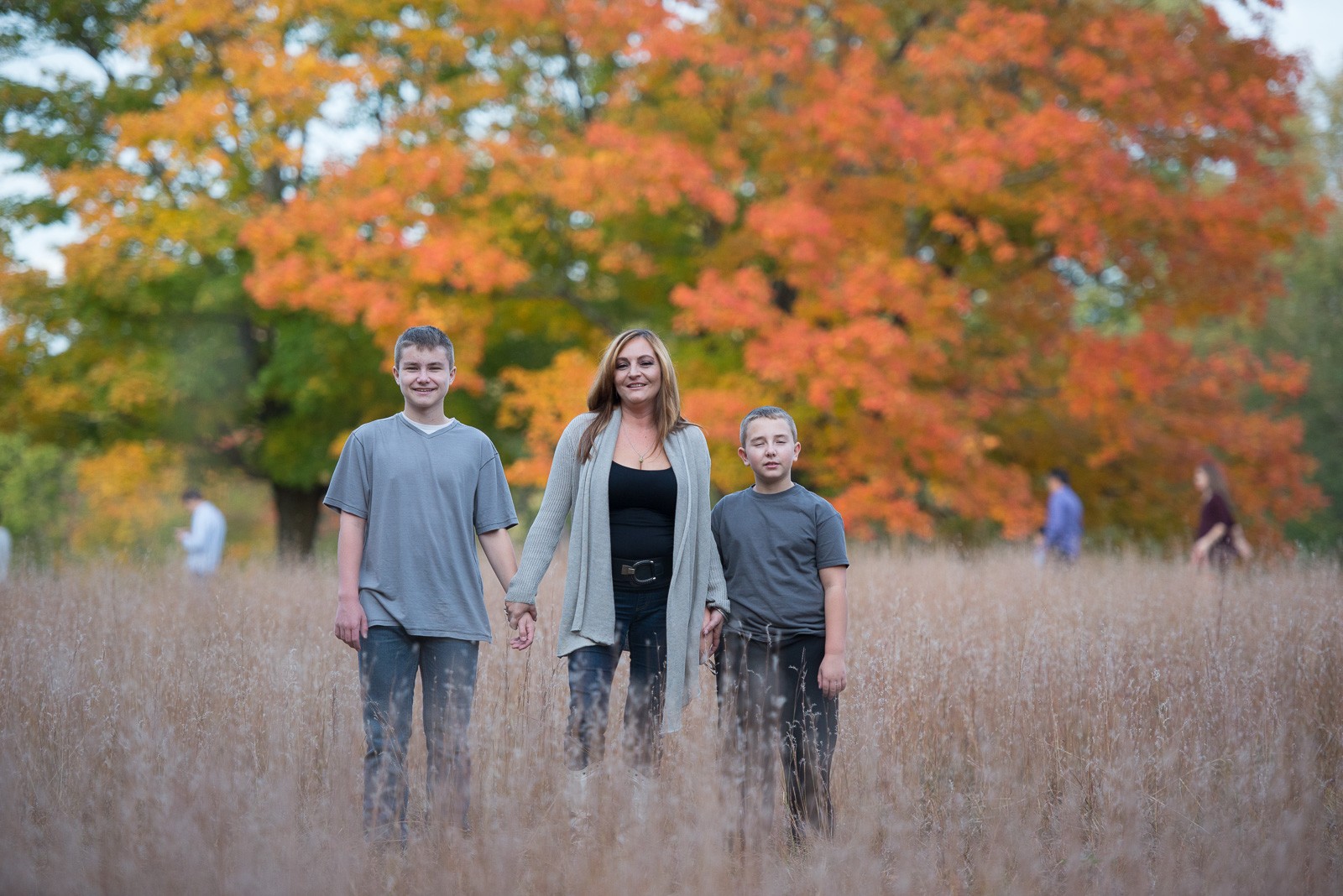 Family under an autumn maple at Francis William Bird Park in Walpole MA