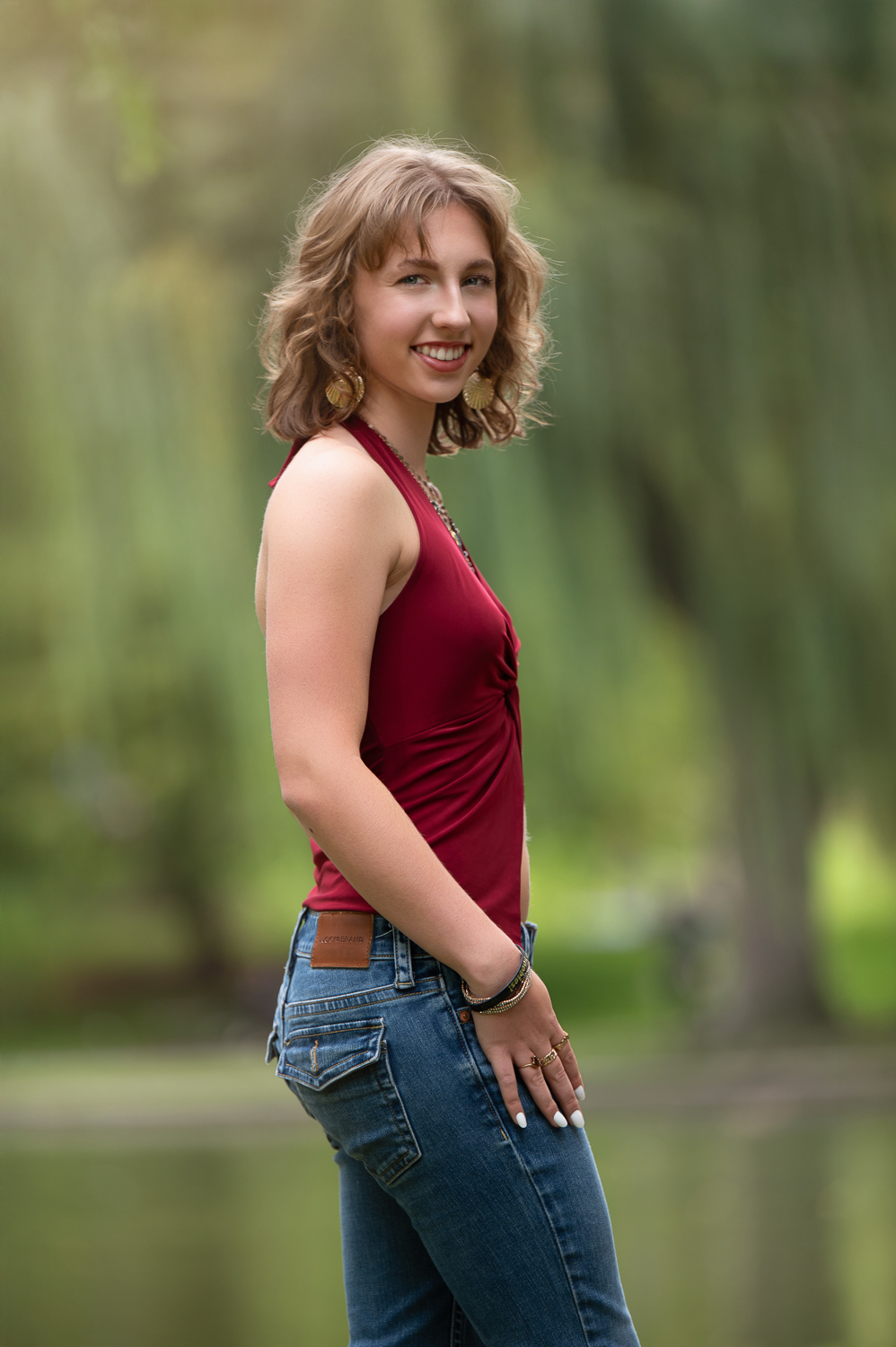 High school senior standing against the weeping willows beside the lagoon in the Boston Public Garden in Boston Massachusetts